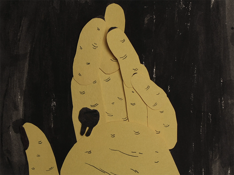 A yellow hand holds a black tooth.